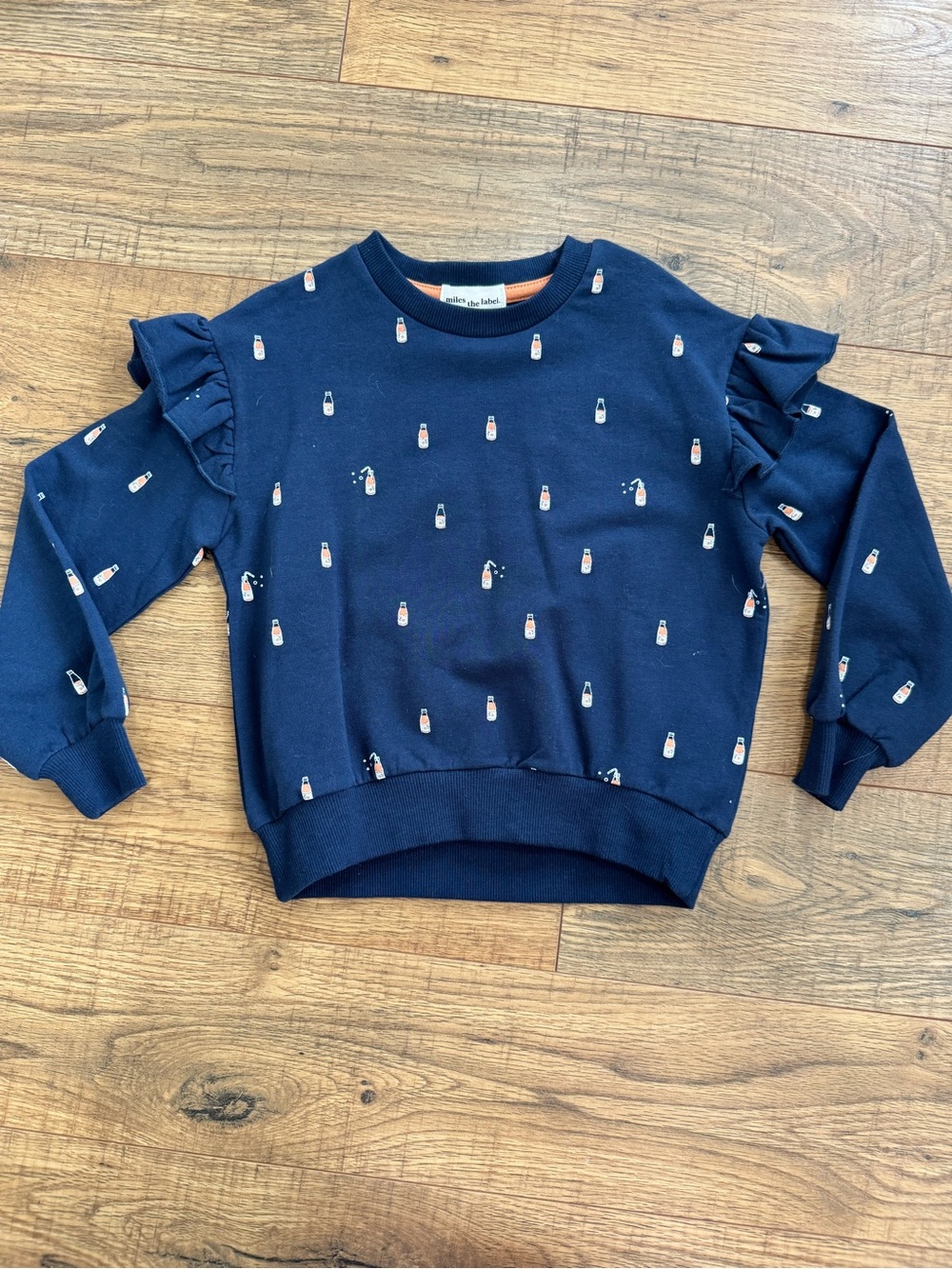 Girls Navy Ruffle Sleeve Sweatshirt with Bottle Motif